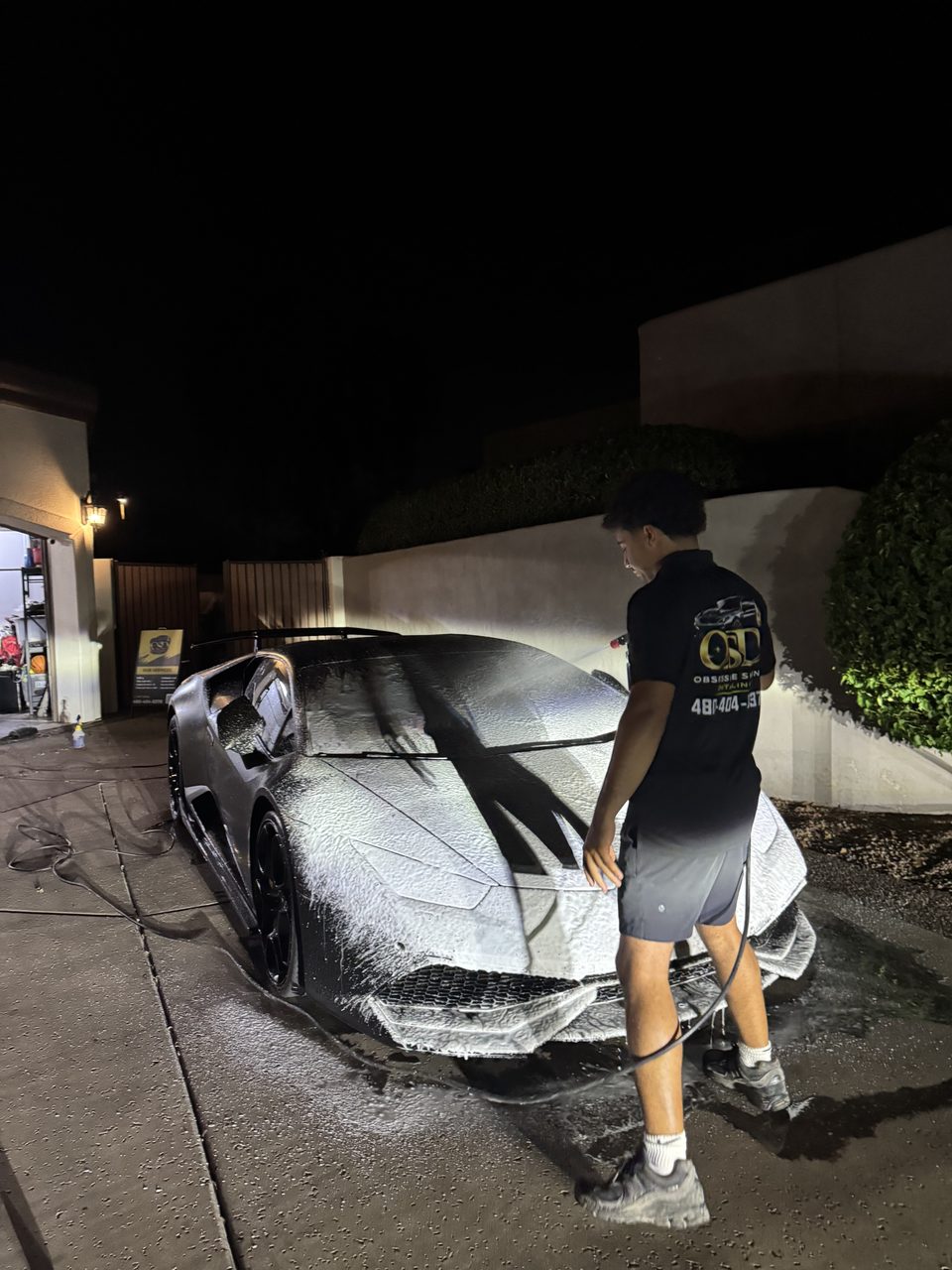 Obsessive Shine detailer foam-washing a Lamborghini on-site in Scottsdale