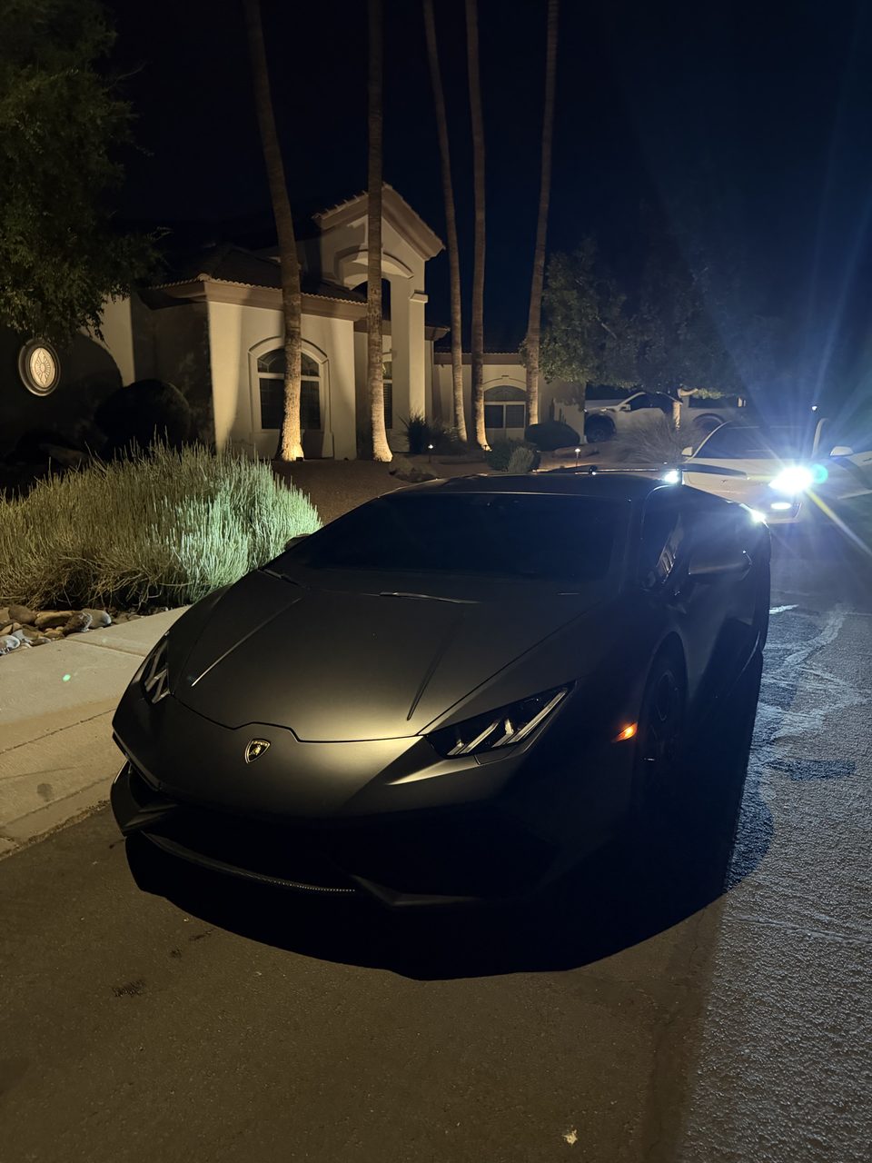 Matte black Lamborghini detailed in a Scottsdale driveway at night